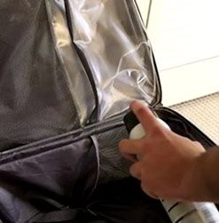 luggage being treated with bed bug luggage spray